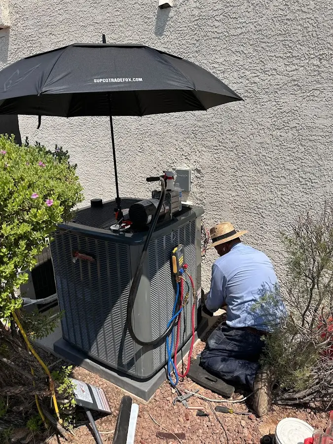 HVAC technician performing outdoor AC maintenance in College Park